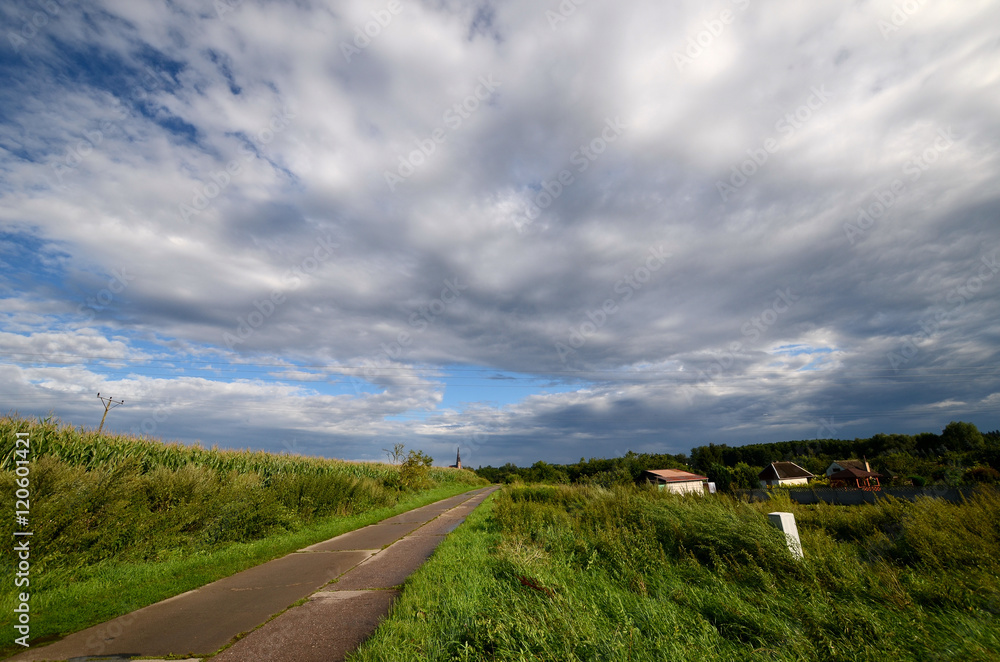Country road under a cloudy sky