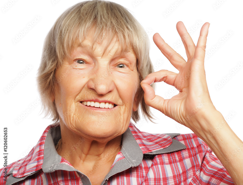 Old happy woman showing ok sign