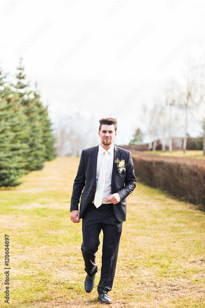 business, season, weather and people concept - young smiling businessman autumn natural background business, season, weather and people concept - young smiling businessman autumn natural background