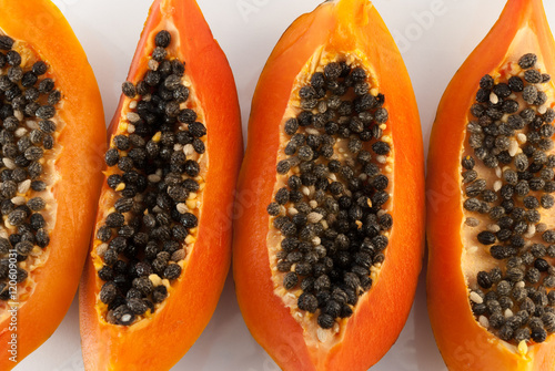 slices of sweet papaya on white background