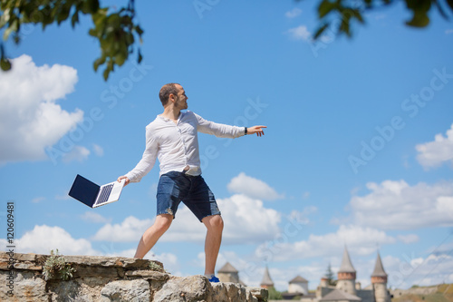 young man throws a laptop