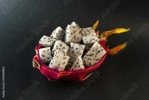 Dragon fruit served for a dessert on black background