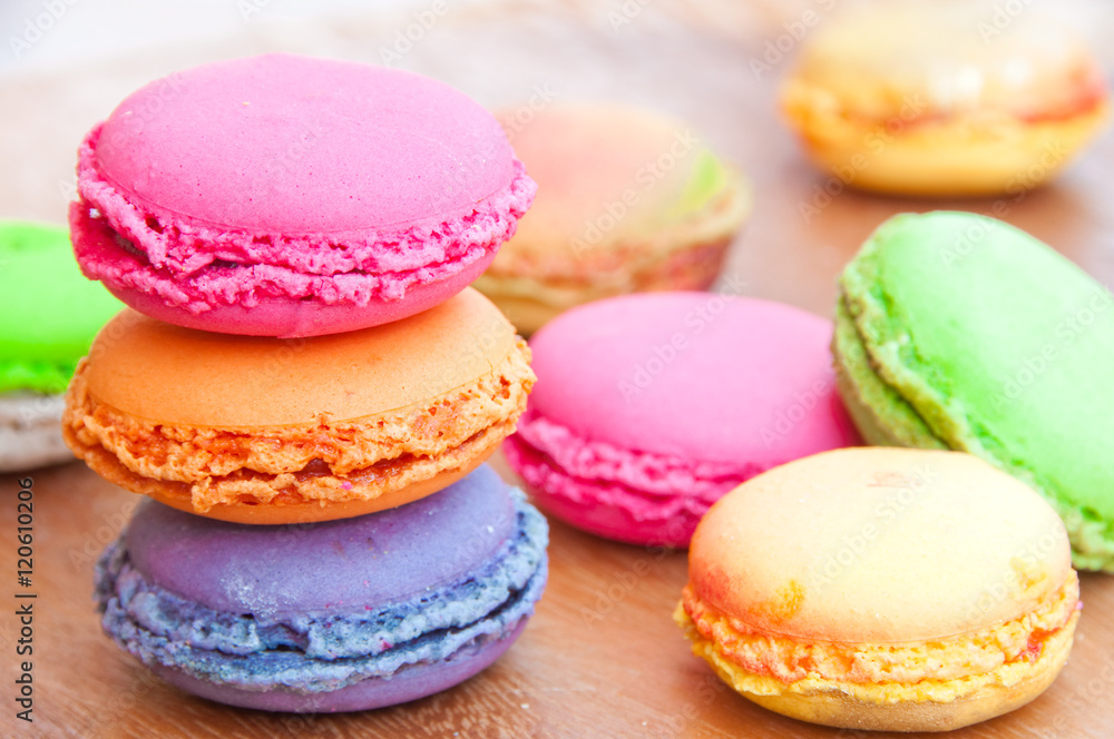 Colorful french sweets macarons on wooden table