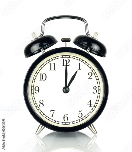 Alarm Clock isolated on white, in black and white, one o'clock. photo