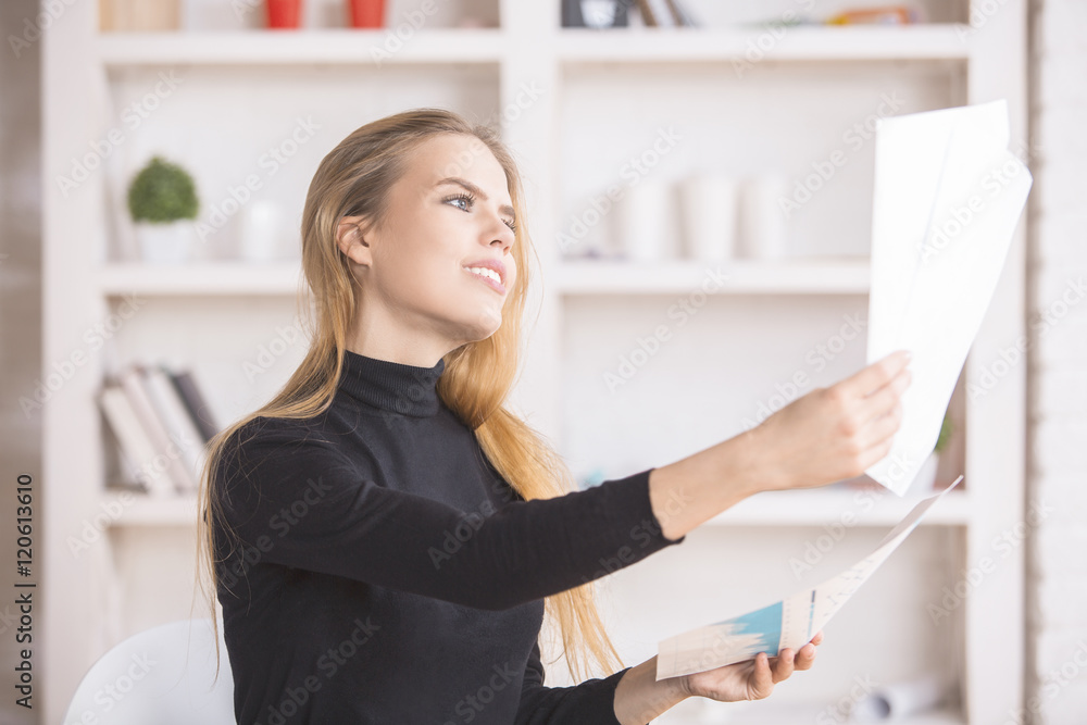 Smiling businesswoman dealing with paperwork Smiling businesswoman dealing with paperwork