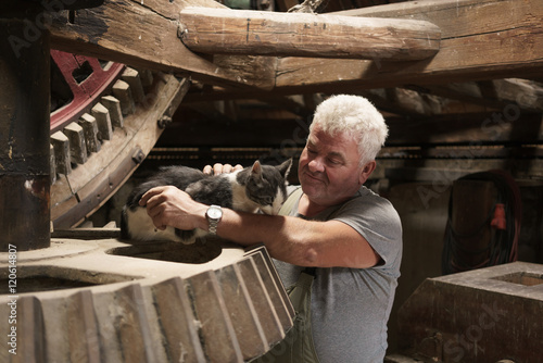 Miller stroking working mill cat