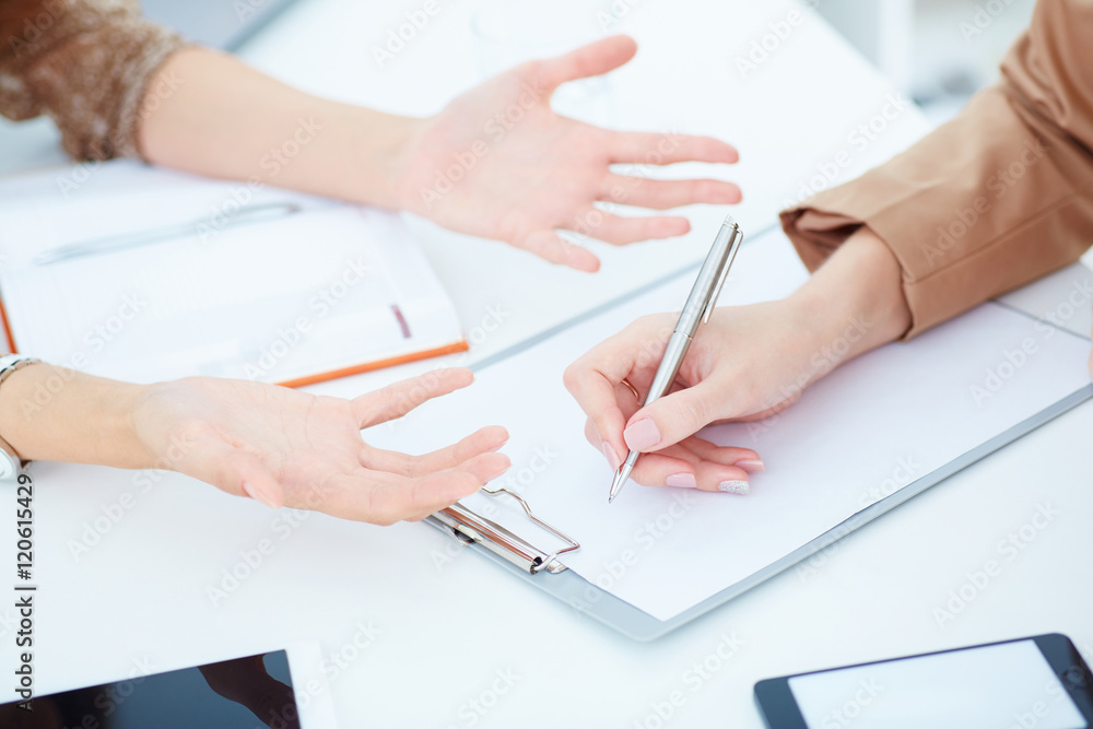 Dismissal, firing and sacking concept. Girl wrote a statement on the dismissal. Сolleague tries to stop her. Dismissal, firing and sacking concept. Girl wrote a statement on the dismissal. Сolleague tries to stop her.