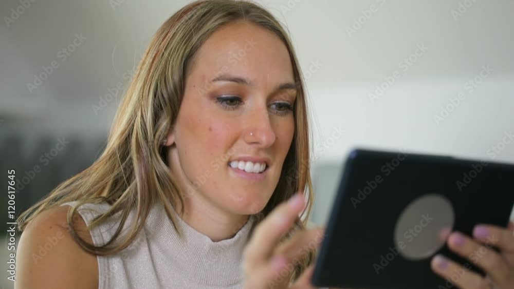 Woman using digital tablet in office Woman using digital tablet in office
