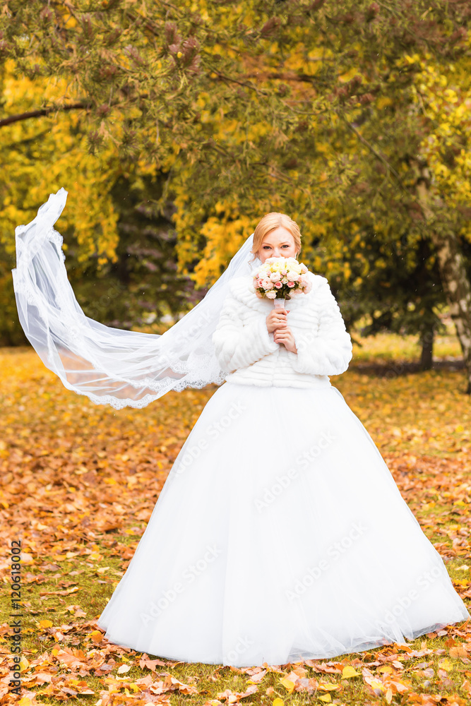 Portrait of a bride in autumn nature with wedding bouquet Portrait of a bride in autumn nature with wedding bouquet