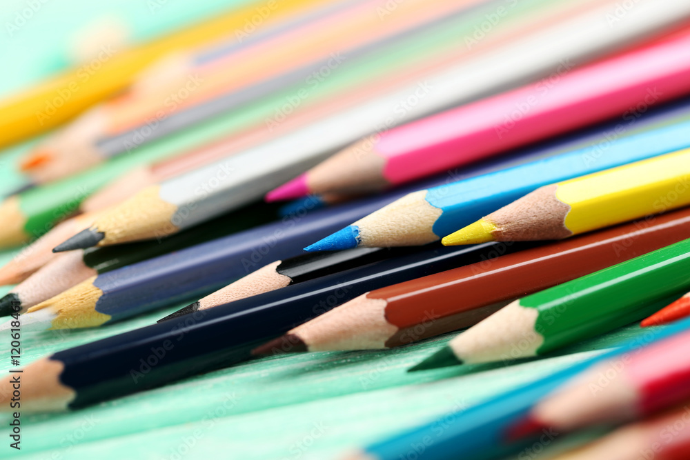 Drawing colourful pencils on a wooden background