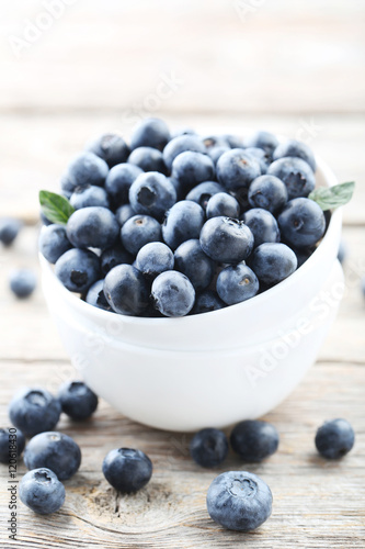 Ripe and tasty blueberries on grey wooden table