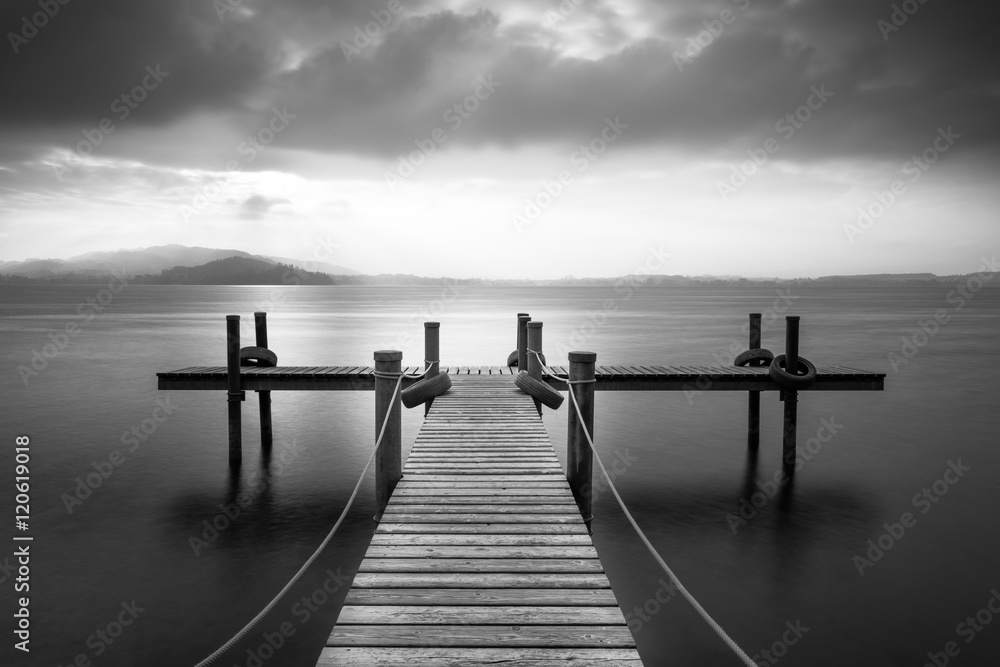 Wooden pier on the lake Zug, Switzerland. Long exposure. Black and White.