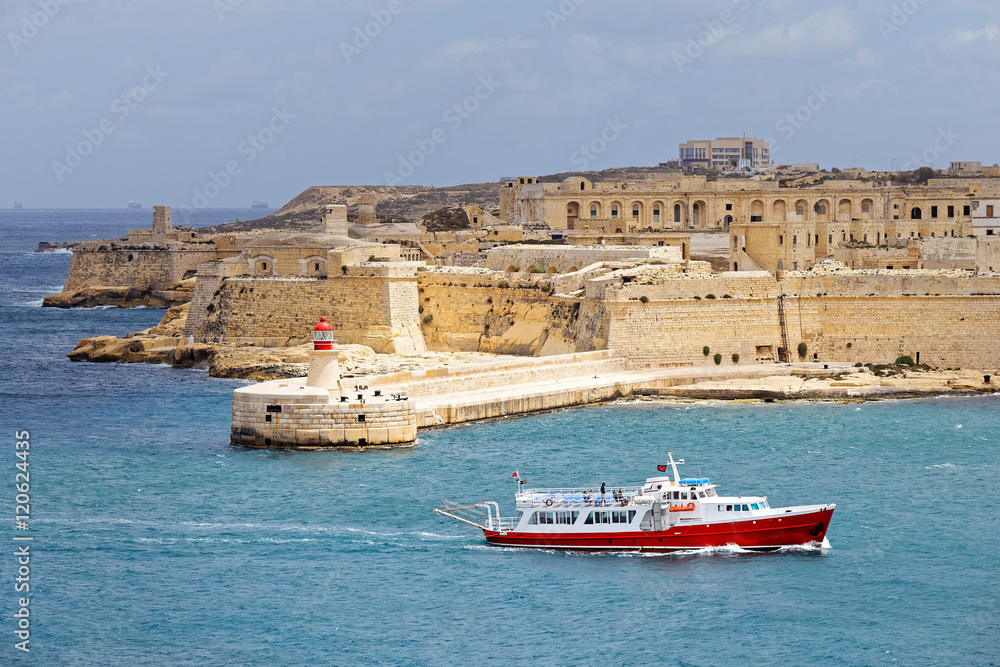 Tourist ship sails in front of St. Elmo, Malta