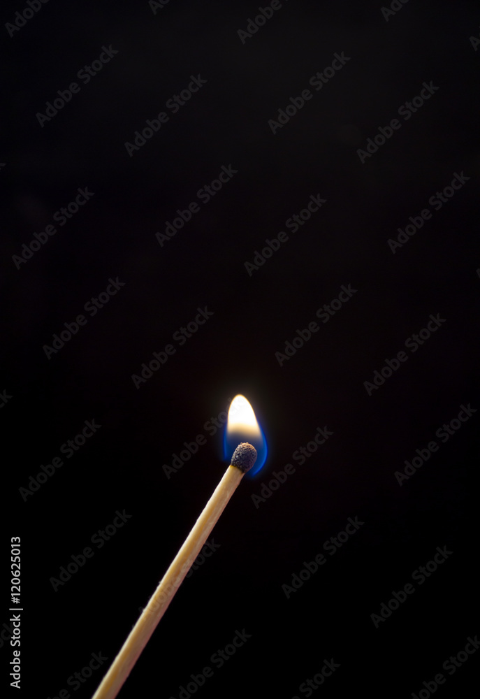Burning match. A photo close up, a dark background Burning match. A photo close up, a dark background