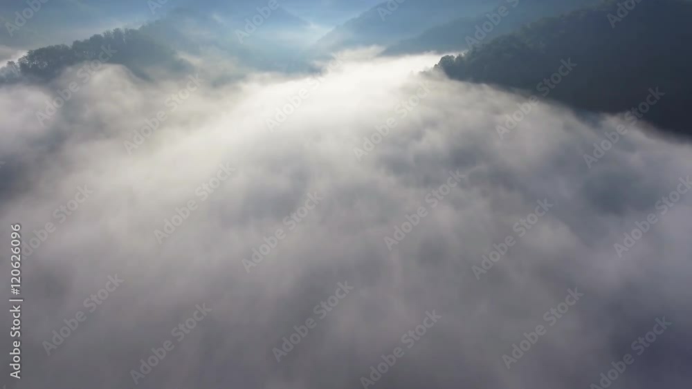 Landscape misty panorama. Fantastic dreamy sunrise on rocky mountains with view into misty valley below. Foggy clouds above forrest. View below to fairy landscape. Foggy forest hills.View from above. Landscape misty panorama. Fantastic dreamy sunrise on rocky mountains with view into misty valley below. Foggy clouds above forrest. View below to fairy landscape. Foggy forest hills.View from above.