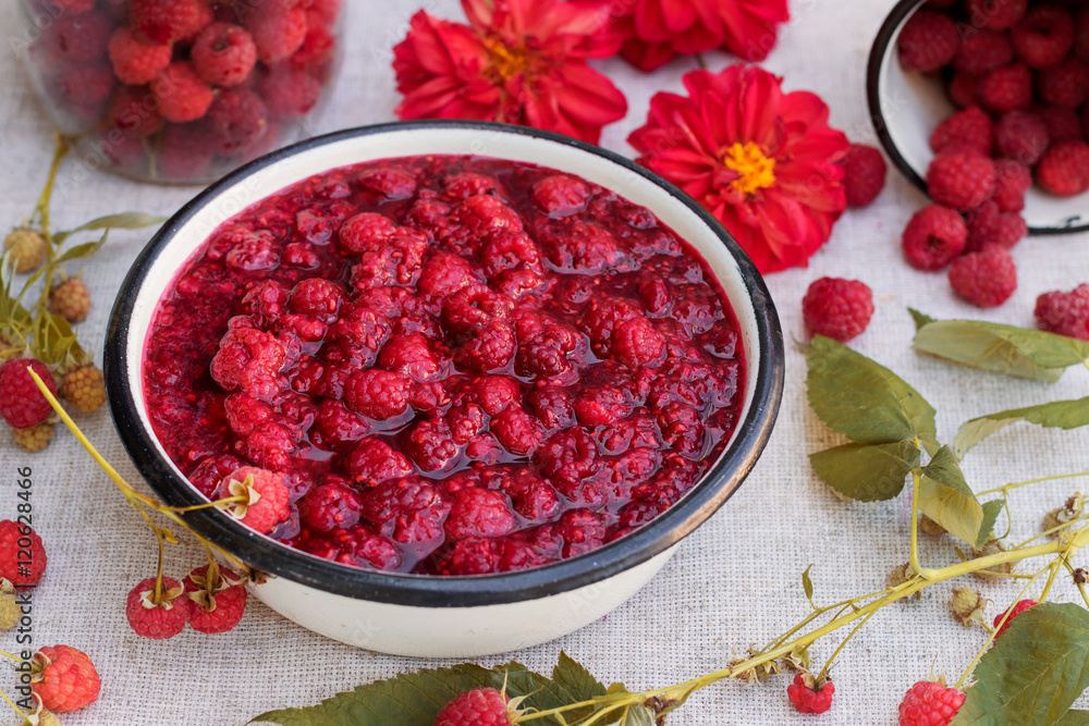 Raspberry jam in a bowl with fresh raspberry and flowers, rustic style. Raspberry jam in a bowl with fresh raspberry and flowers, rustic style.