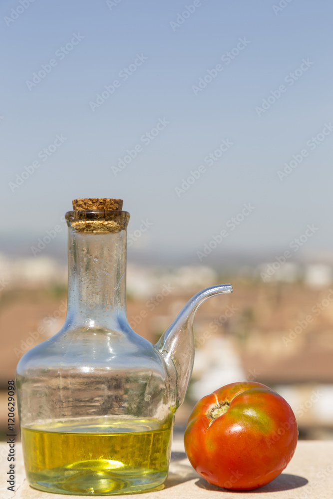 Obraz premium oil and tomato with the city in the background