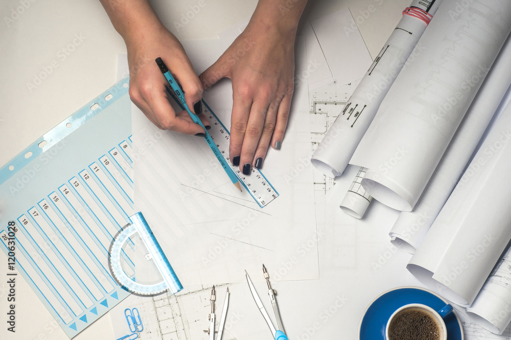 © Lyudmyla V - Architect working on blueprint. © Lyudmyla V - Architect working on blueprint.