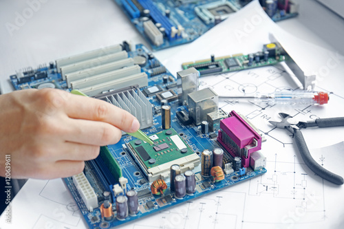 Man repairing motherboard, ...