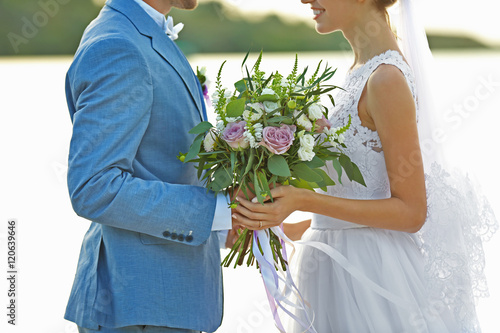 Happy wedding couple on riv...