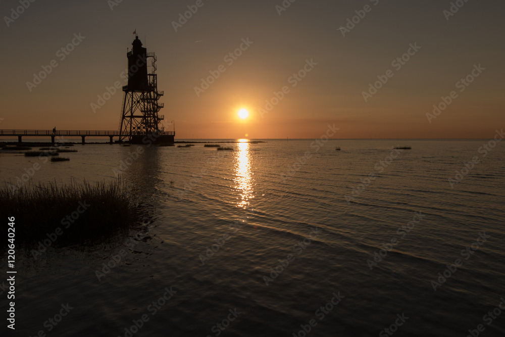 Wurster Nordseeküste - Leuchtturm Overeversand neben dem Sonnenuntergang