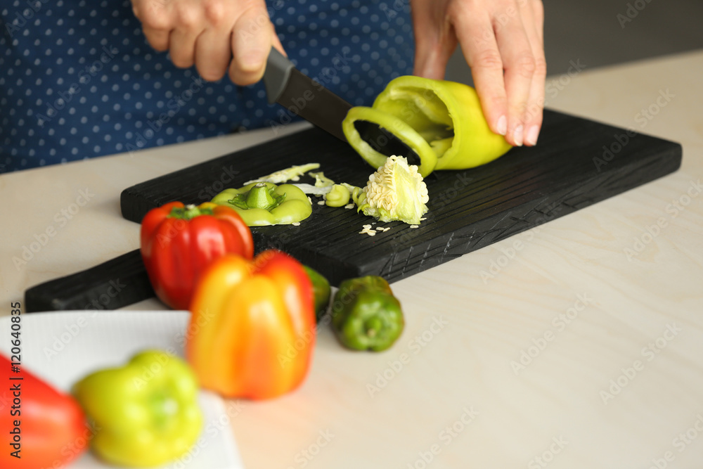 Woman preparing peppers in kitchen Woman preparing peppers in kitchen