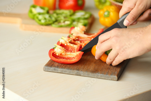 Woman preparing peppers in kitchen