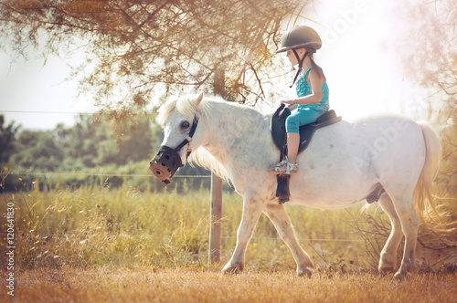 Little girl on the horse. White poni. © steftach