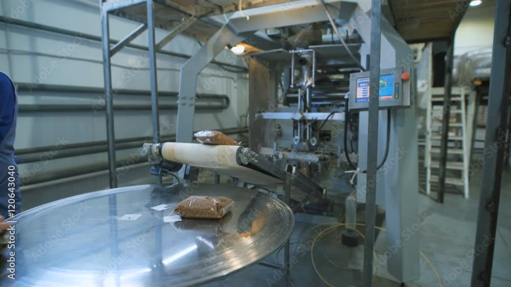 Food industry. bags of buckwheat groats on the conveyer to go dalnayshey packing and shipping to stores. Food industry. bags of buckwheat groats on the conveyer to go dalnayshey packing and shipping to stores.