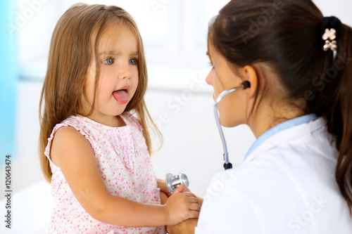 Doctor examining a little girl by stethoscope