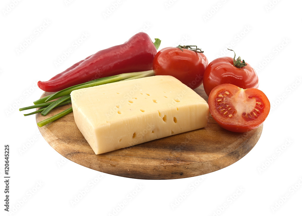 Vegetables and cheese on cutting board, isolated on white Vegetables and cheese on cutting board, isolated on white
