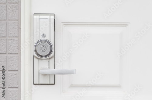 Modern door handle with security system lock on wood door