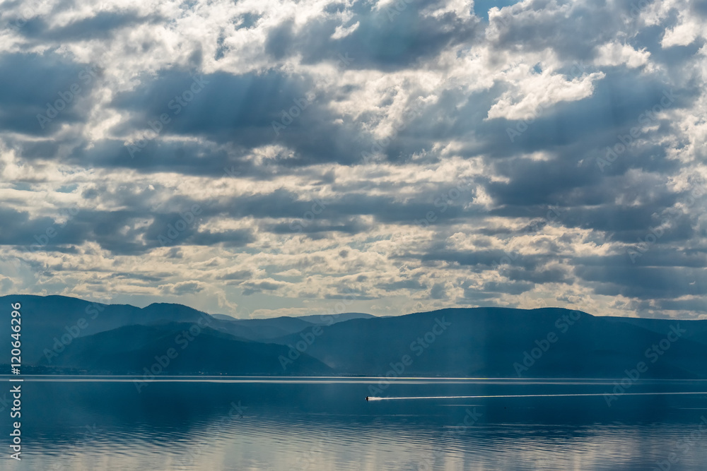 Light passes through the clouds on the lake Baikal
