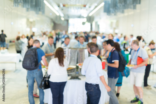 Abstract blurred people socializing during buffet lunch break at business meeting or conference. photo