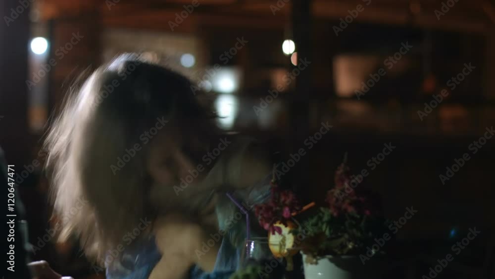 Sincere emotions of happy young woman laughing and talking cheerfully at date Sincere emotions of happy young woman laughing and talking cheerfully at date