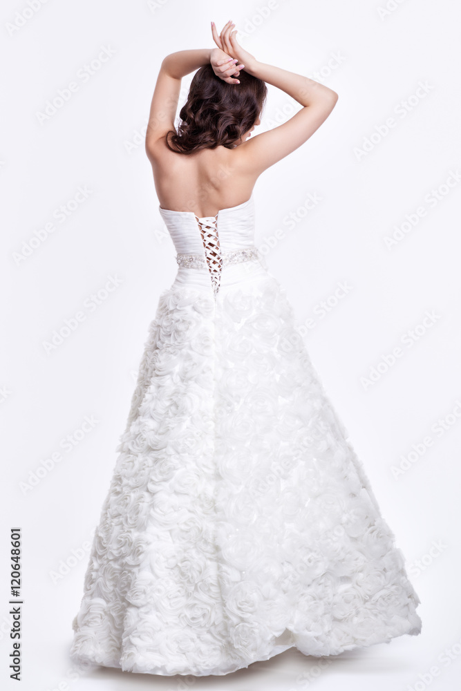 Fototapeta premium Portrait of beautiful young brunette woman bride in white Weddin