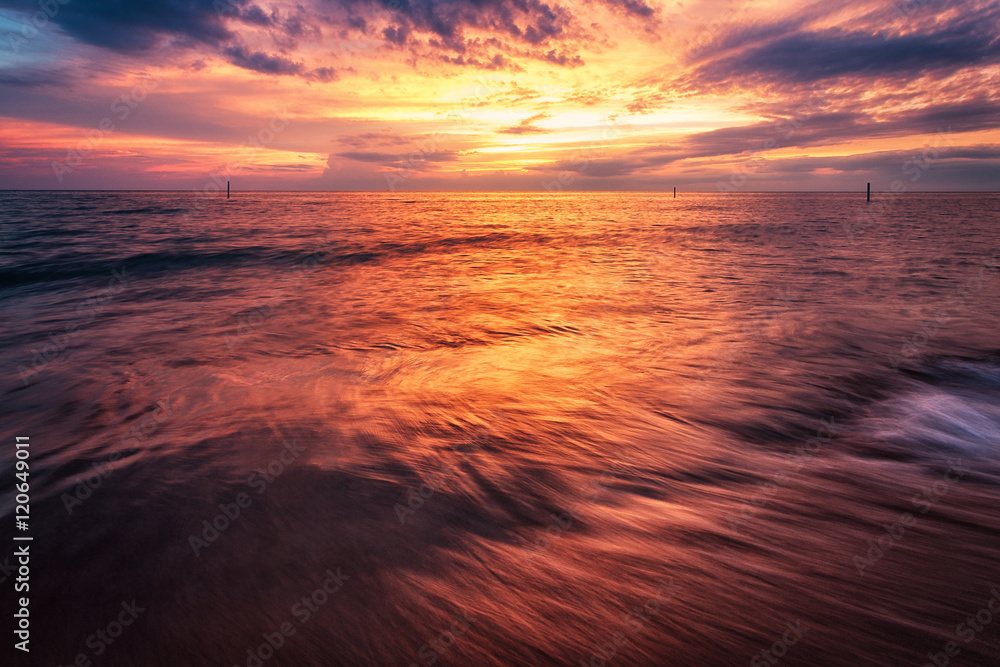Dramatic Seascape Sunset. Vibrant Flowing Water Waves.