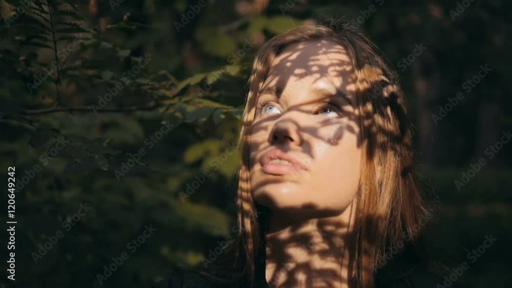 Close up portrait of beautiful young brunette sexy woman hair blowing in wind in forest Close up portrait of beautiful young brunette sexy woman hair blowing in wind in forest