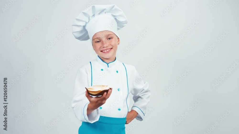 Baker holding cake with cream and gives you it. Chef 7-8 years smiling at camera. Isolated on white Baker holding cake with cream and gives you it. Chef 7-8 years smiling at camera. Isolated on white