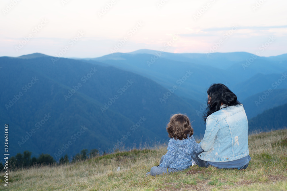 Back of mother and son in the mountains Back of mother and son in the mountains