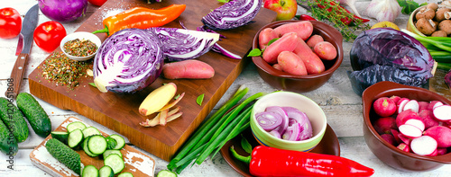 Fresh fruits and vegetables on wooden board.