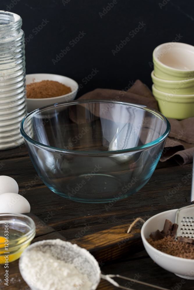 Empty glass bowl with ingredients for cooking chocolate cake Empty glass bowl with ingredients for cooking chocolate cake