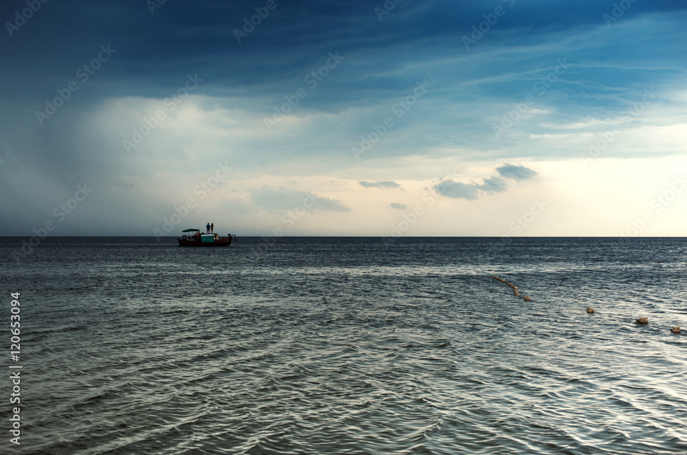 Sea boat on the background of cloudy sky Sea boat on the background of cloudy sky
