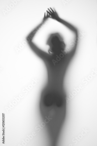 silhouette of a pregnant woman from behind and arms outstretched on a light background