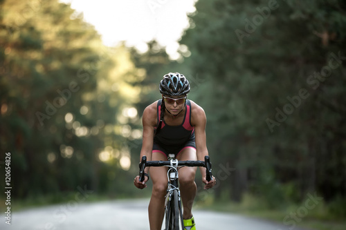 Athletic girl rides a bike