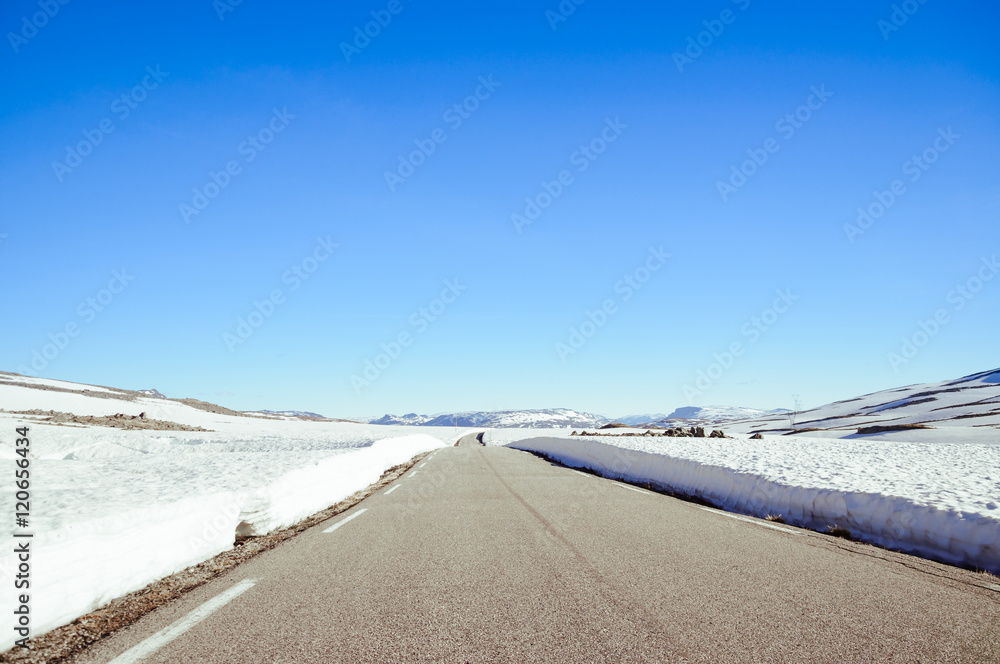 snowy road in winter mountains of norway, tindevegen snowy road in winter mountains of norway, tindevegen
