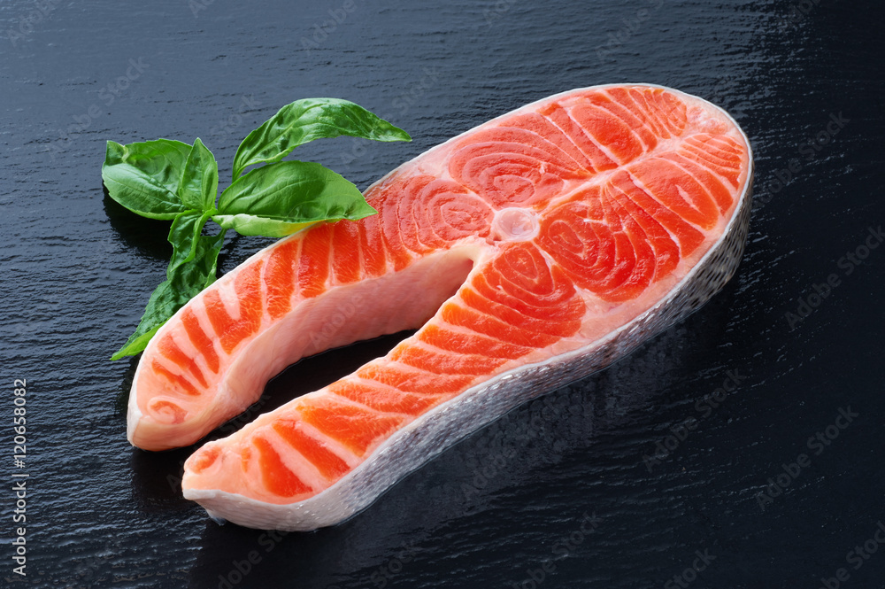 Fresh salmon with basil on a dark background Fresh salmon with basil on a dark background