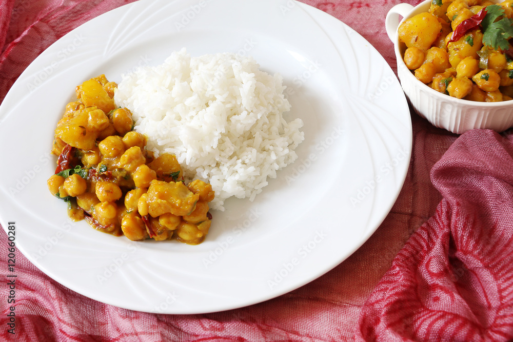 Chickpeas and potato curry served with rice Chickpeas and potato curry served with rice