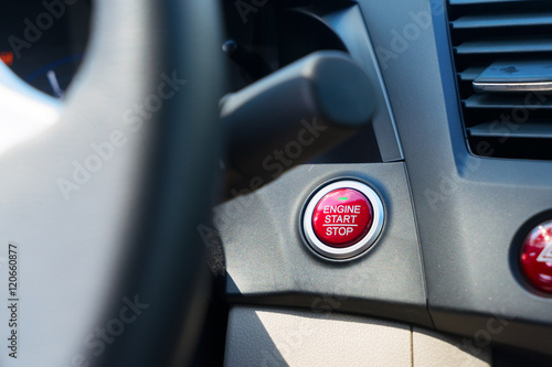 Start engine button on modern car dashboard close up