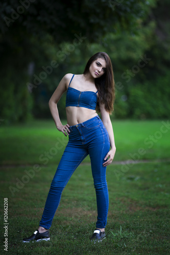 Full length portrait of a beautiful young caucasian woman in blue jeans and denim top, clean skin, long hair and casual makeup,